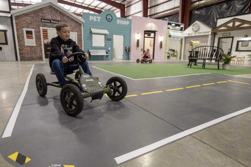 Young Boy drives around Lincway's Kids Play Town